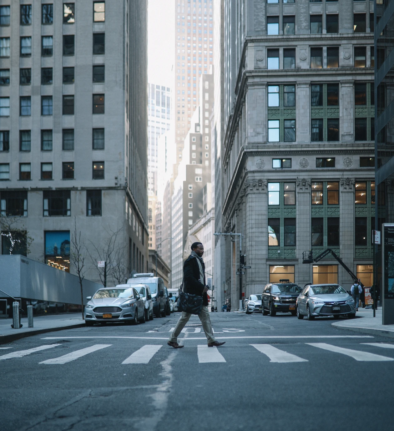 Man walking on crosswalk in cityscape