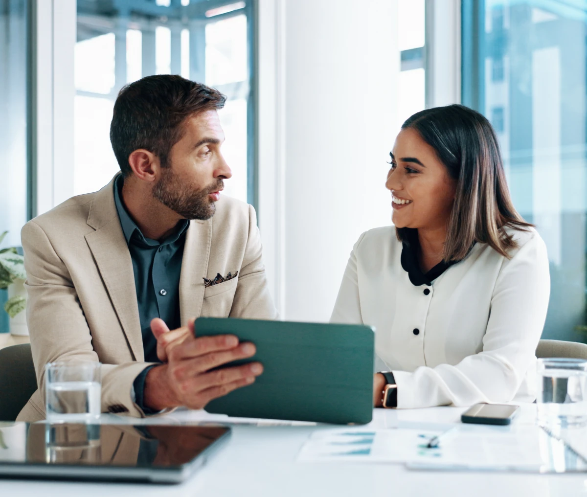 Colleagues discussing work at a table